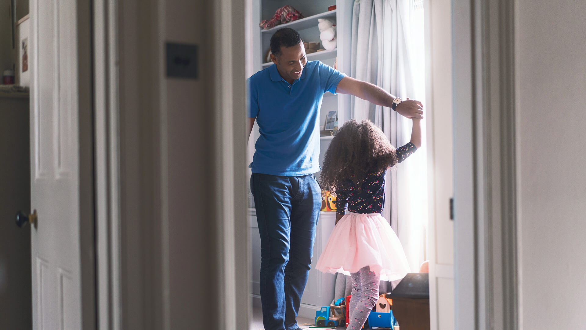 Happy Father Dancing With Daughter In Bedroom