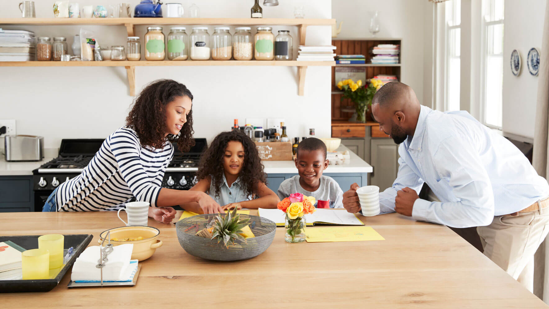 Young Black Family Busy Together In Their Kitchen
