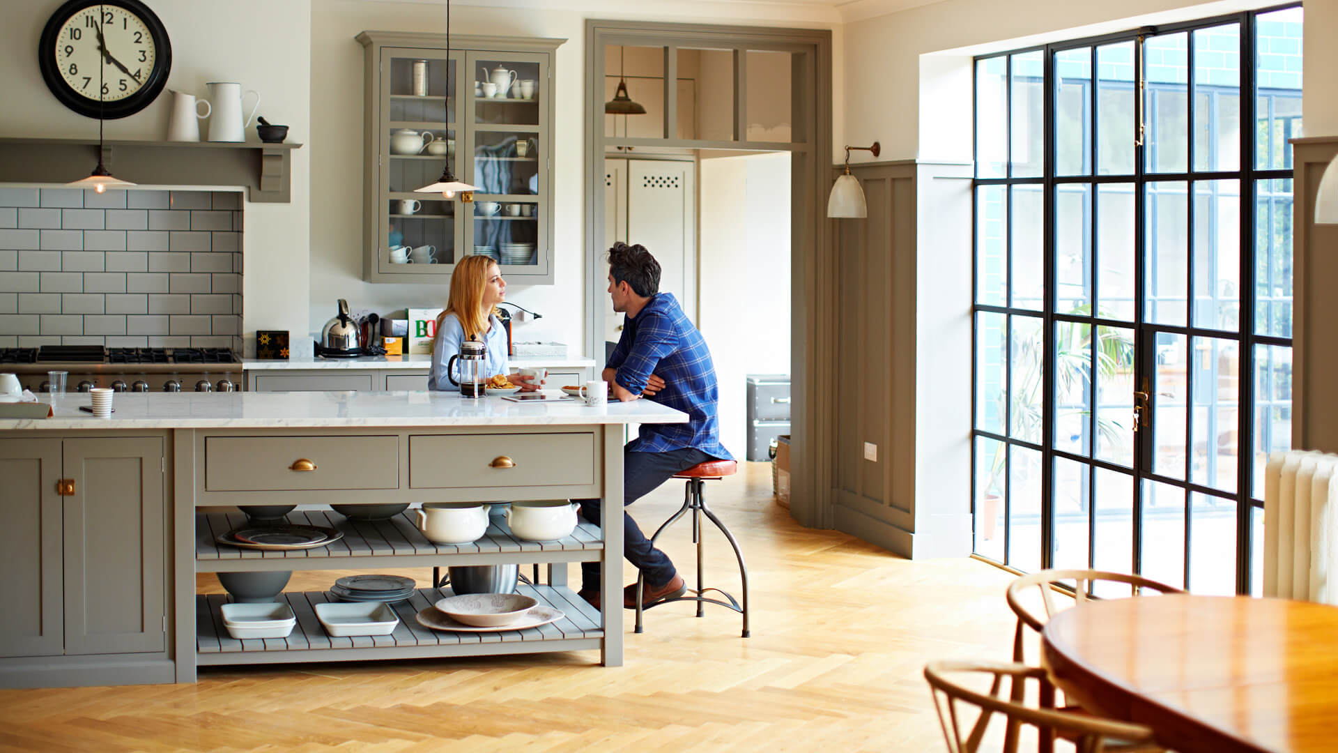 Couple In Kitchen Having Conversation