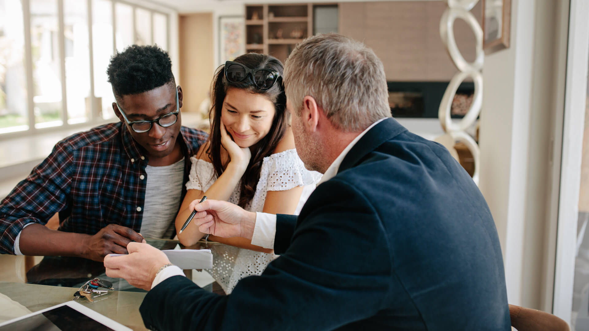 Realtor Reviewing Document With Couple